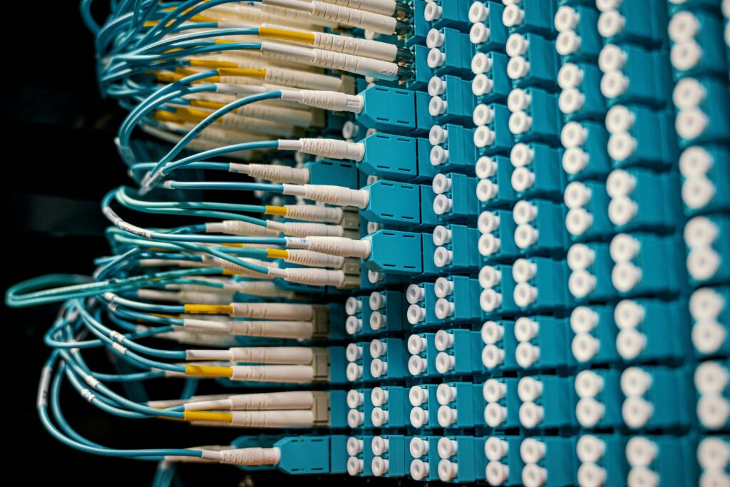 pexels photo 4339335 4339335 Close-up of a network patch panel with connected blue fiber optic cables.
